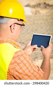 Architect On Building Site Using Digital Tablet