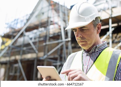 Architect On Building Site Using Digital Tablet
