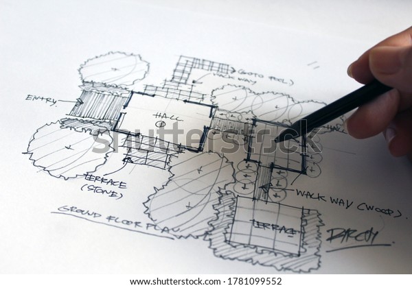 Architect, pencil sketch, house plan with black\
wooden pencil