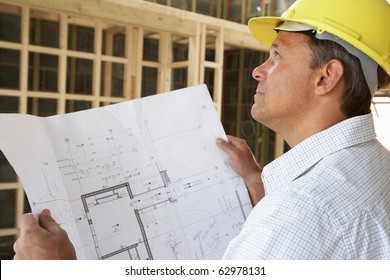 Architect With Plans In New Home