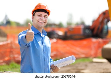 Architect showing ok sign in a construction site