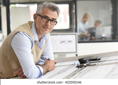 Architect sitting at drawing table in office
