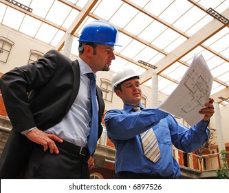  Architect And Supervisor Reviewing Blueprints