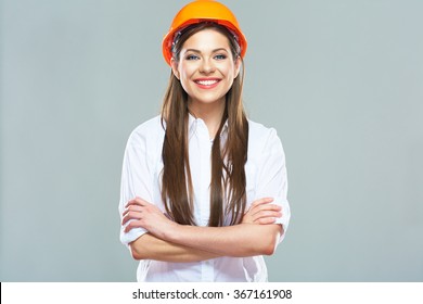 Architect woman isolated portrait with crossed arms. Woman wearing protect helmet.