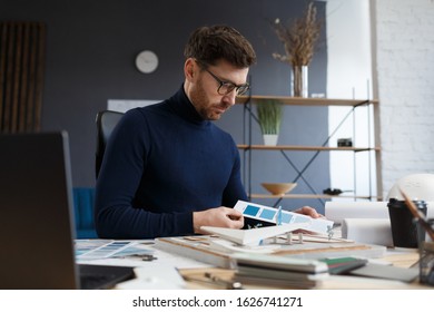 Architect working in office with color palette. Engineer select colors for building using color swatches, searching new ideas for construction project. Portrait of handsome bearded man at workplace. - Shutterstock ID 1626741271