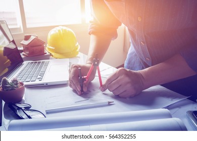 Architect working on blueprint. Architects workplace - architectural project, blueprints, ruler, calculator, laptop and divider compass. Construction concept. Engineering  tools,selective focus - Powered by Shutterstock