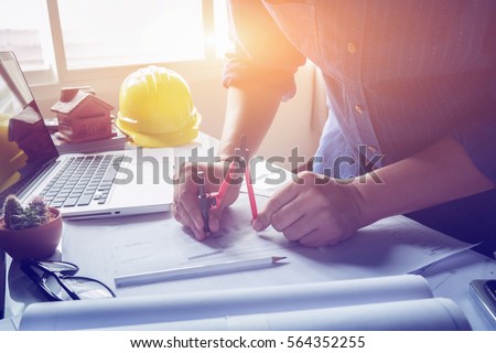 Architect working on blueprint. Architects workplace - architectural project, blueprints, ruler, calculator, laptop and divider compass. Construction concept. Engineering  tools,selective focus