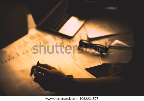 Architect working on\
blueprint. Architects workplace - architectural project,\
blueprints, ruler and divider compass. Construction concept.\
Engineering tools,selective\
focus