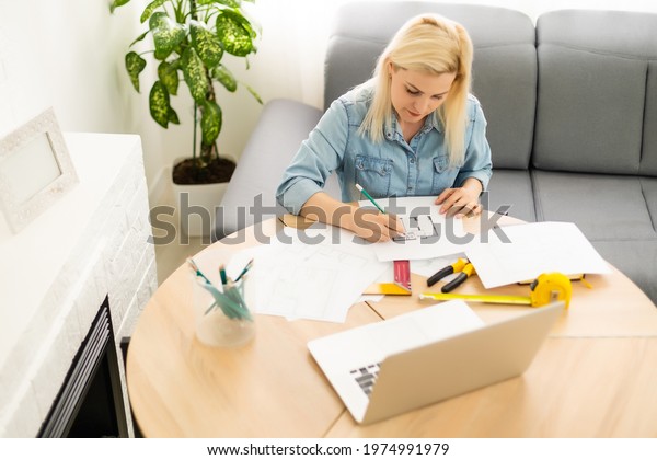 Architect working\
on blueprint. Architects workplace - architectural project,\
blueprints, ruler, calculator, laptop and divider compass.\
Construction concept. Engineering\
tools