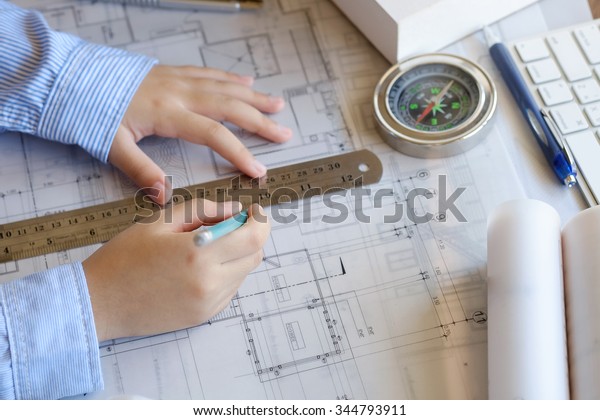 Architect working on blueprint. Architects\
workplace ,architectural\
project