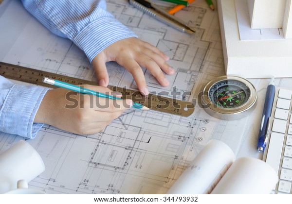Architect working on blueprint. Architects\
workplace ,architectural\
project