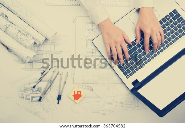 Architect working
on blueprint. Architects workplace - architectural project,
blueprints, ruler, calculator, laptop and divider compass.
Construction concept. Engineering
tools