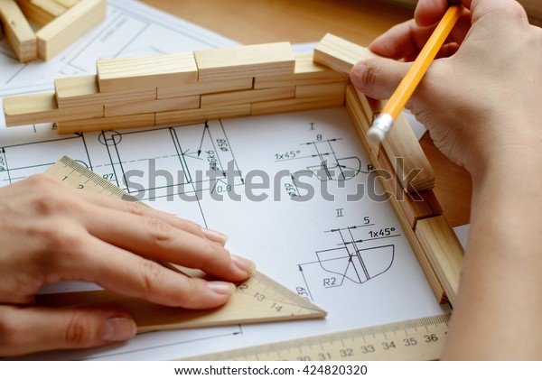 Architect working on blueprint. Architects workplace -\
architectural project, blueprints, ruler. Construction concept.\
Engineering tools. 