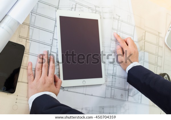 Architect working\
on blueprint. Architects workplace - Architectural project\
blueprints drawings Engineering\
tools