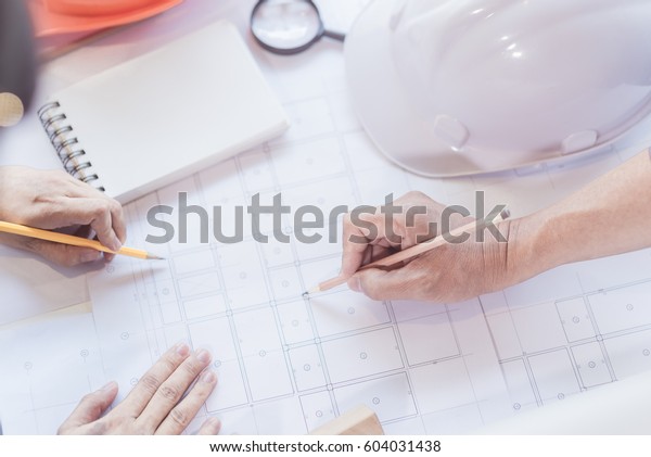 Architect working on blueprint. Architects workplace\
- architectural project. Construction concept. Engineering tools.\
Top view