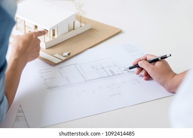 Architect working on blueprint, Engineer meeting working with partner colleagues and engineering tools for architectural project, Construction concept. - Shutterstock ID 1092414485