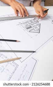 Architect working on blueprint on paper. The designer draws a sketch of the house. - Shutterstock ID 2126254688