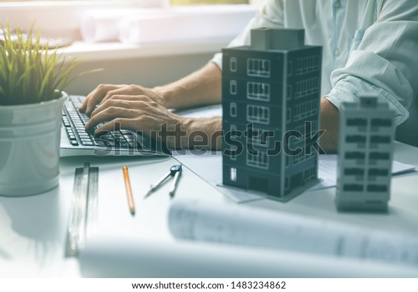 architect working on computer in office typing
on keyboard