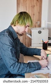 Architect Working On Project In Office. Architect Designing House For Client. Young Man With Green Hair.