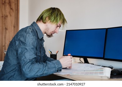 Architect Working On Project In Office. Architect Designing House For Client. Young Man With Green Hair.