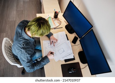 Architect Working On Project In Office. Architect Working With Blueprints. Young Man With Green Hair. Top View.