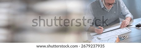 Architect working on a project and using a ruler; panoramic banner