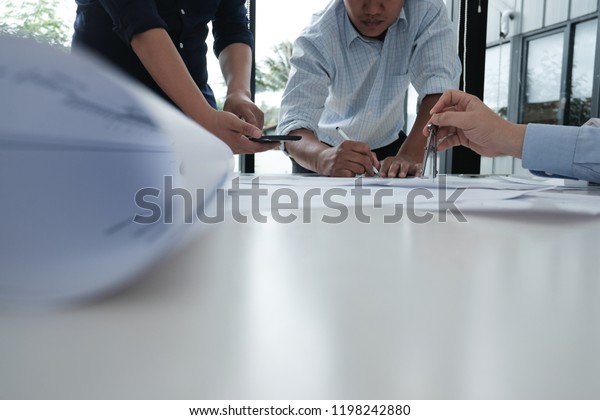 architect working on\
real estate project with partner at workplace. engineer discussing\
with colleague on living house blueprint at office. construction\
& building\
concept