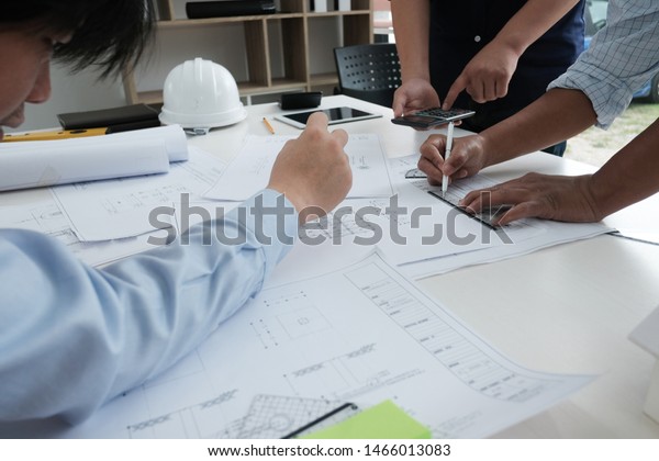 architect working on
real estate project with partner at workplace. engineer discussing
with colleague on living house blueprint at office. construction
& building
concept