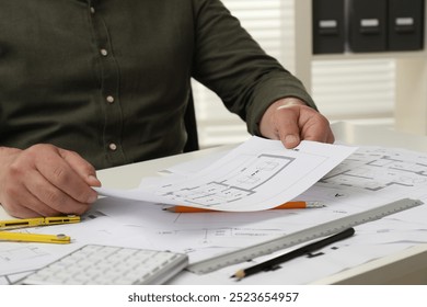 Architect working with project, closeup. Different technical drawings on white table