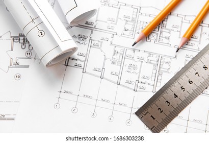 Architect workplace top view. Architectural project, blueprints, blueprint rolls on table. Construction background. Engineering tools. Copy space