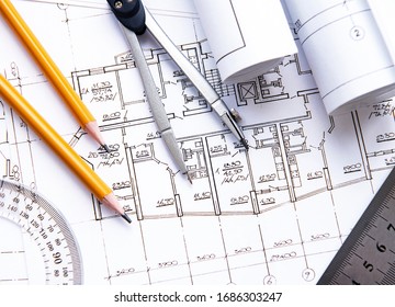 Architect workplace top view. Architectural project, blueprints, blueprint rolls on table. Construction background. Engineering tools. Copy space