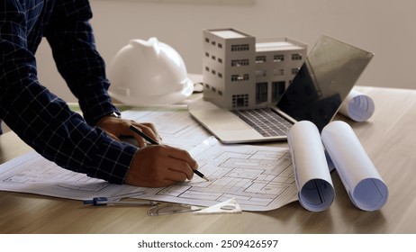 Architects concept, engineer architect designer freelance work on start-up project drawing, construction plan architect design working drawing sketch plans blueprints and making construction model - Powered by Shutterstock