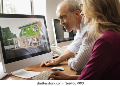 Architects Discussing A Green Construction Project, Designing And Building Efficient Environmentally Friendly Buildings. Green Architectural Practice.