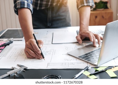 Architects are drawing project at work.