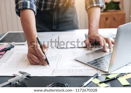Architects are drawing project at work.