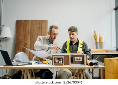 Architects and engineers collaborating on blueprints and models, showcasing teamwork, planning, and design in architecture and construction projects. - Powered by Shutterstock