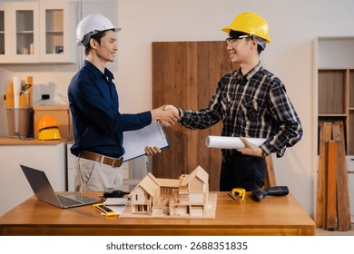 architects and engineers shake hands while working for teamwork and cooperation after completing an agreement in an office facility, successful cooperation concept.