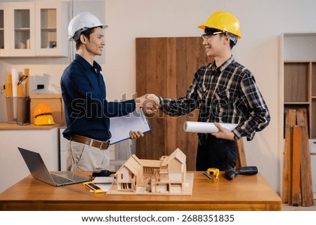 architects and engineers shake hands while working for teamwork and cooperation after completing an agreement in an office facility, successful cooperation concept.