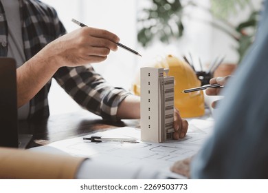 Architects and engineers are working together to edit the draft building plan that was designed after it was presented to the client and partially revised the design. Interior design and decoration