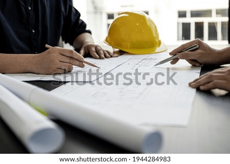 Architects and engineers are working together to edit the draft house plan that was designed after it was presented to the client and partially revised the design. Interior design and decoration ideas