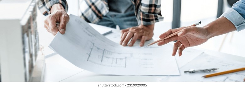 Architects interior designer hands working with Blue prints and documents for a home renovation for house design
