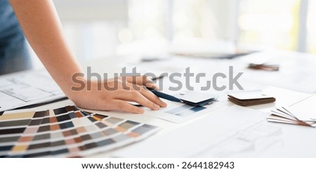 Architects, interior designers, creative project plans, house designs and selects interior materials with material samples on the table.