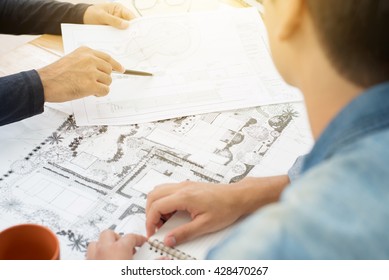 Architects (landscape Designers) Discussing Blueprints