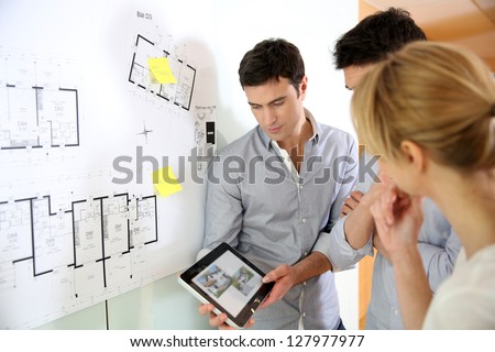 Architects in office looking at construction project