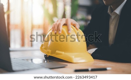 Architects use laptops to detail their work, hard safety helmet on table, protection against danger, Work Safety Concept ,safety care from an accident, prevention of possible injuries, safety first,