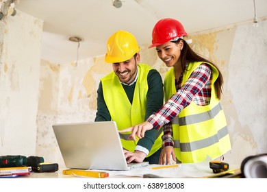 Architects Using Laptop At Construction Site, Teamwork