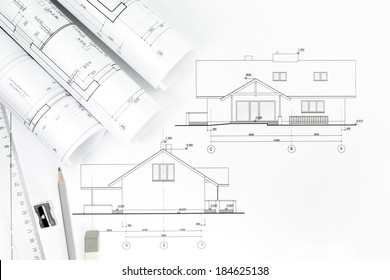 Architect's work table with technical drawings and work tools - Powered by Shutterstock