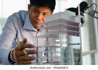 Architects worked thinking design architecture with building model, Design from his idea stationery on desk office. Startup and analysis of the architecture of building structure. - Powered by Shutterstock - Get 15% off with code: PIKWIZARD15