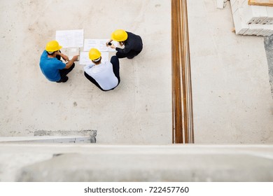 Architects and worker at the construction site.