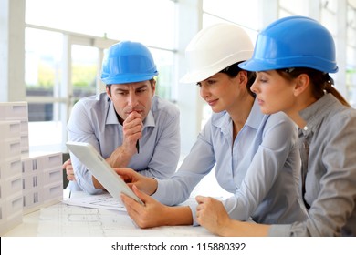 Architects working in office on construction project